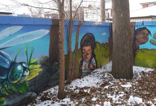 corner of wall, interior angle, with mural painted on it, kids outside