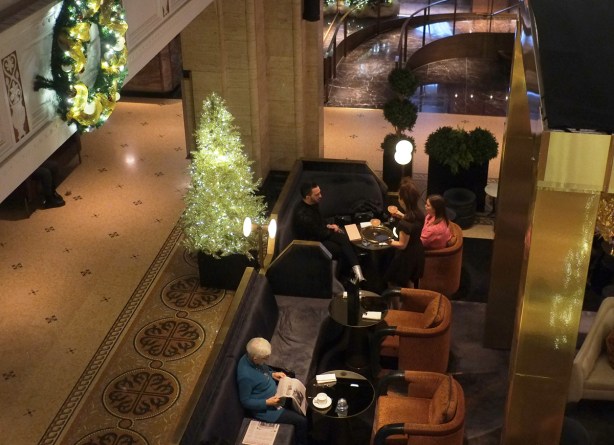 looking down into cafe area of royal york hotel, people eating, talking, and reading newspaper