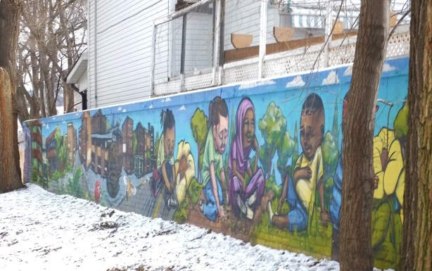 portion of wall painted by Elicser Elliot and Nick Sweetman, people outside,