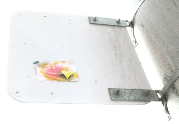 small sticker on the back of a traffic sign that started as a hello my name is sticker, small yellow heart on it