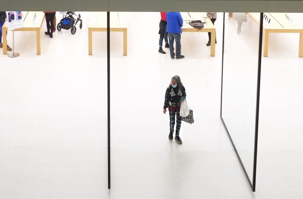a woman comes out of the apple store at the eaton center
