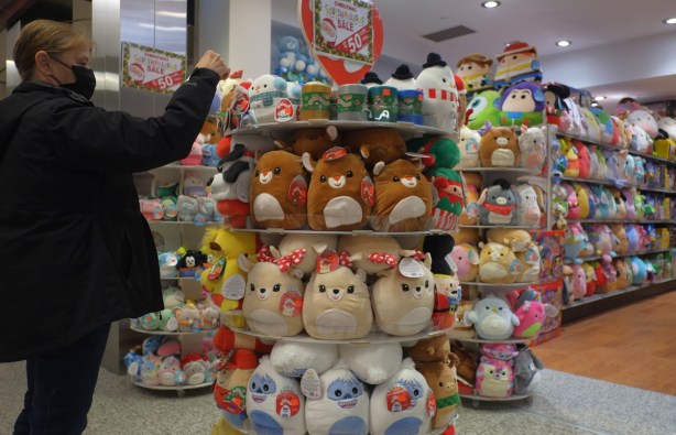 lots of stuffies on shelves, for sale for christmas time, mallow, round characters, 