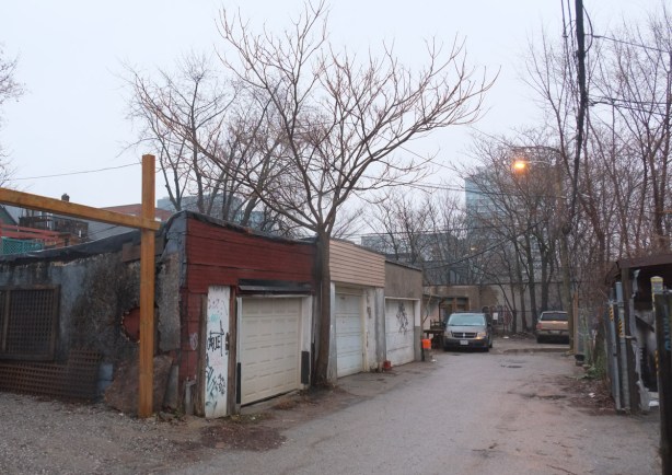 alley with old garages behind Queen Street West, trees, winter scene but no snow 
