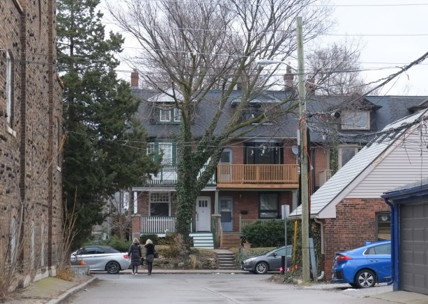 2 houses on Bowden Avenue, 3 storeys high, one with a large wood balcony