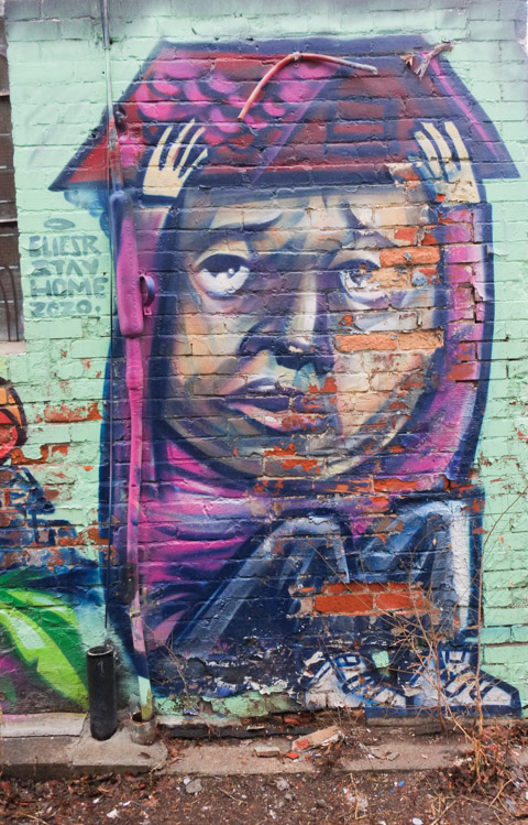 Elicser Elliott stay at home mural from 2020. A young man holds a roof over his head