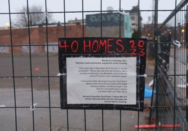 sign on a metal construction fence around a vacant lot with title 40 homes 2023, description of fight to build affordable housing 