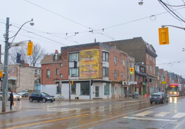 building at the southwest corner of Gerrard and Logan, has a yellow ghost sign for Lumberking
