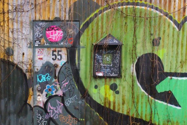 street art and graffiti and a large mailbox by the door of number 55