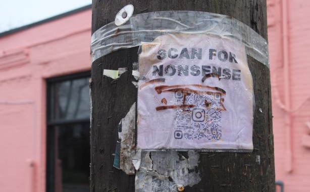 paper on a wood utility pole, scan for nonsense, graffiti 