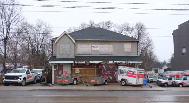 old tavern building on Gerrard St., boarded up, now a u-haul truck and trailer rental location