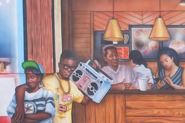 part of a mural by Christiano De Araujo, a young man has a ghetto blater to his ear and his arm around a young woman, in front of a restaurant window where there are people sitting 