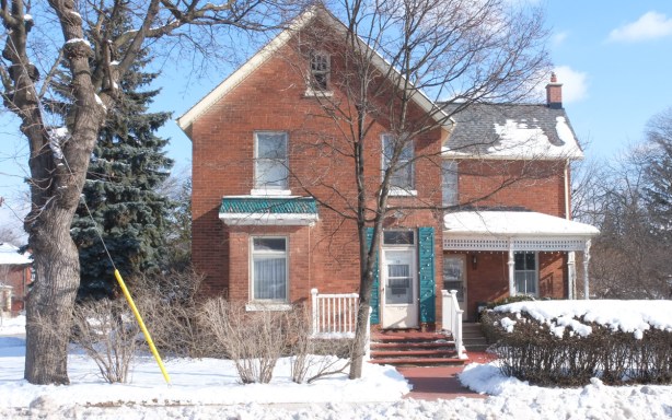 two storey brick house, green shutters