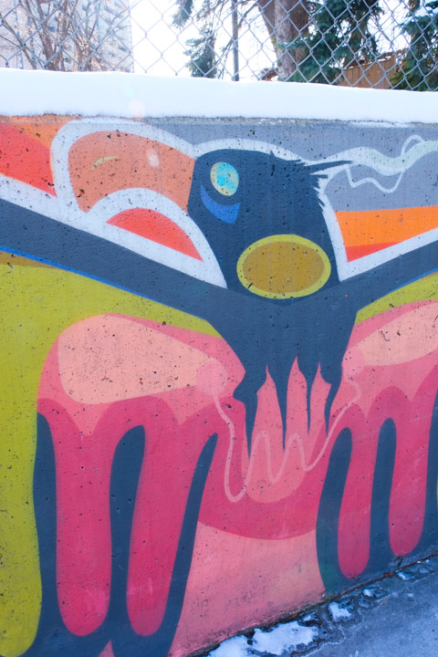 part of a mural by Que Rock a blue thunderbird or eagle with green and pink parts too
