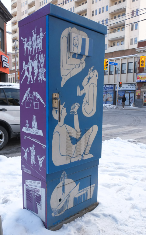 painted metal sidewalk box, purple on one side and blue on the other, white people doing things painted on the purple and blue background