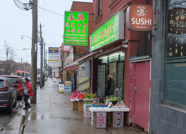 sushi restaurant, a fruit and vegetable store, and other shops on Broadview