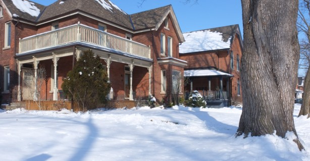 houses with big front porches and balconies, snow, big tree