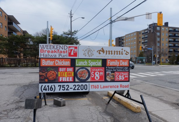 restaurant advertisement sign in parking lot on Lawrence East, for Ammi's Restaurant