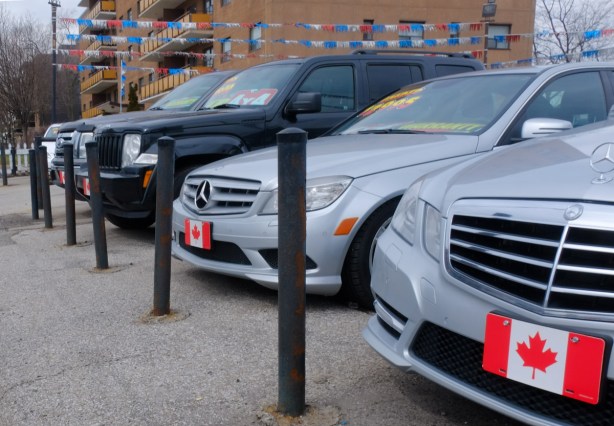cars for sale with Canadian flag licence plates on front, 