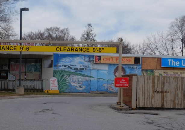 mural on a wall beside a tim hortons drive through