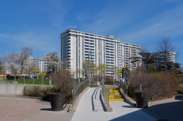 view from entrance of science centre, curved outdoor stairs, apartment building in background
