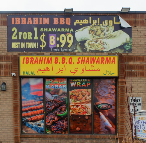 Ibrahim BBQ and Shawarma restaurant window with pictures of items on the menu