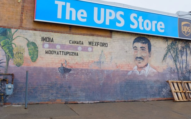 Man's portrait on mural with route that he took from India, Moovattuphuza, Canada, Wexford