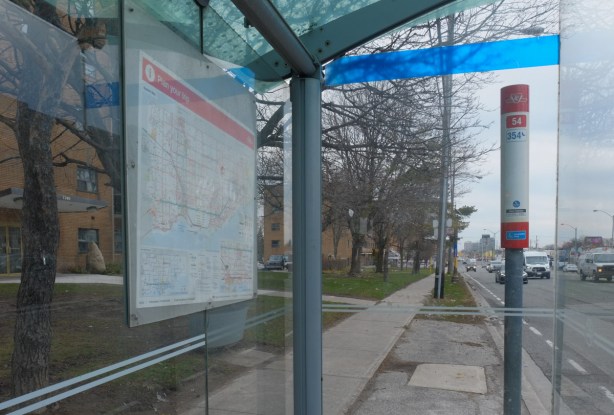 view of lawrence avenue east as seen through a bus shelter