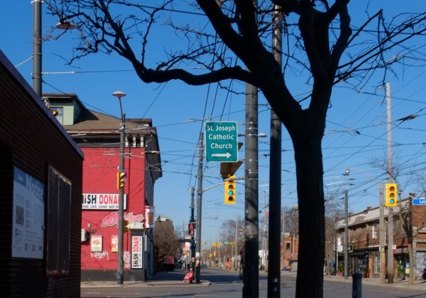 Leslie and Queen Street east, looking west on Queen towards The Duke, a bright red building, restaurant and bar. 