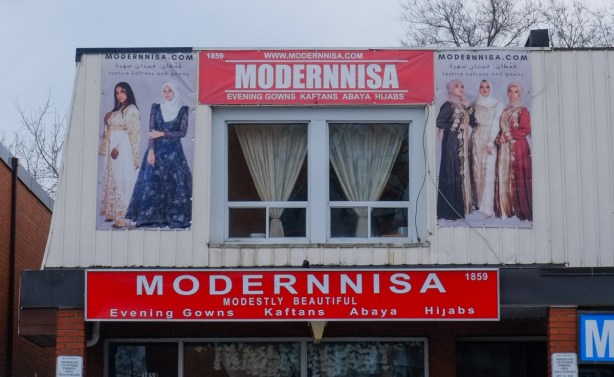window and front wall of Modernnisa women's clothing store with floor length dresses and head scarves