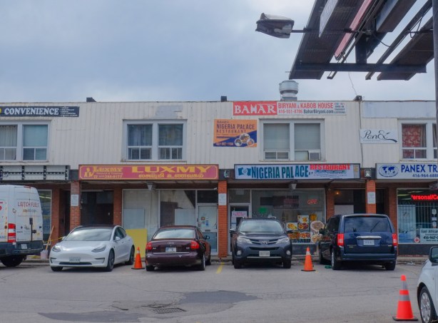 businesses in two storey pale grey brick strip mall
