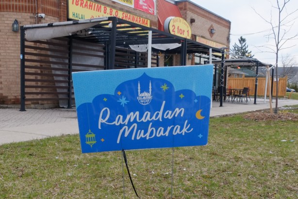 Ramadan Mubarak sign on lawn of restaurant