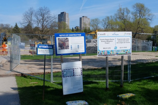 signs around a construction site, ravine erosion mitigation work, as well as drilling for new subway line