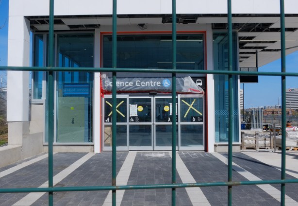 metal construction fence in front of the science centre lrt station that is being built at Don Mills and Eglinton, 
