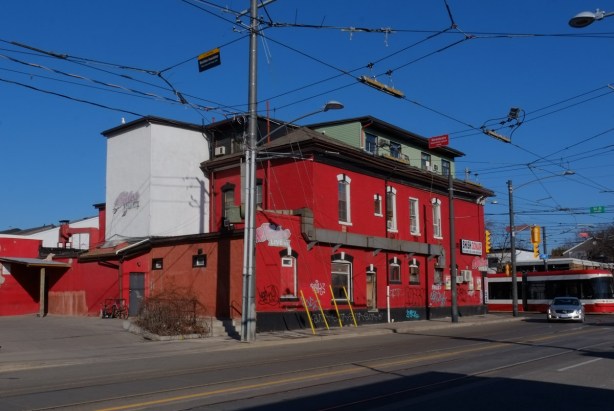 The Duke, a bright red building, seen from Leslie Street south of Queen