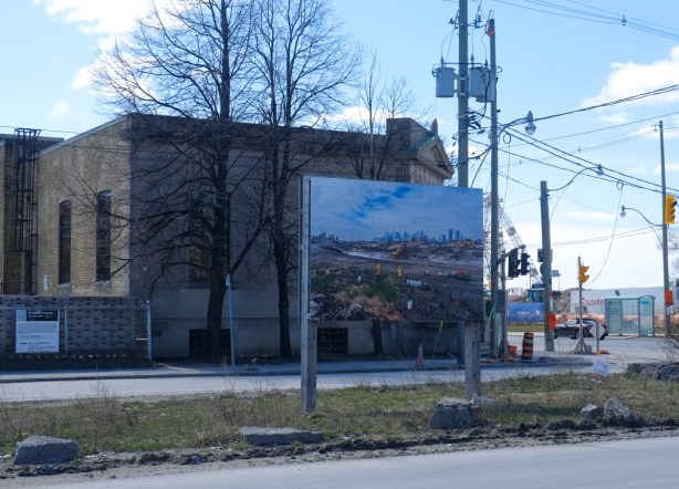 large photograph by Vid Ingelevics and Ryan Walker mounted like a billboard on Villiers street