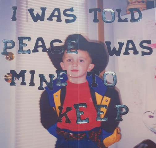 a contact photography festival image, as a large mural, by Jake Kimble showing the artist as a young boy dressed up as a cowboy with large text added to photo that says I was told that the peace was mine to keep