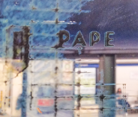 reflections of pape station sign, from the artwork on the walls of that station