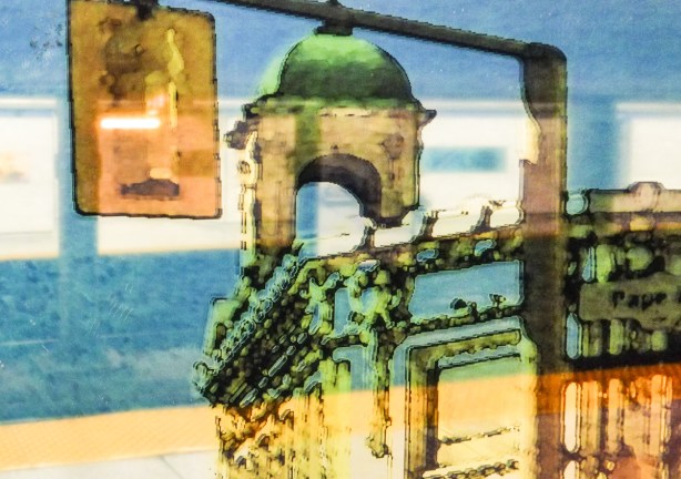 reflections of building on Danforth ear Pape, tower with green domed roof, from the artwork on the walls of that station
