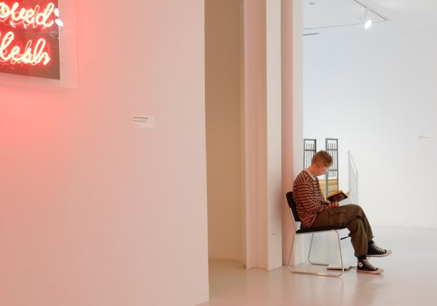 woman sitting in a chair in an art gallery