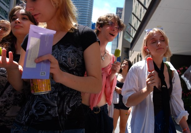 people on sidewalk with popsicles, pride parade, 