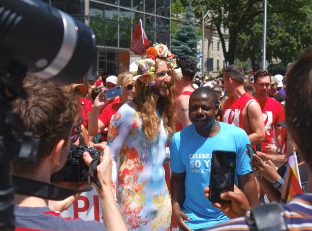cameras and people interviewing before pride parade
