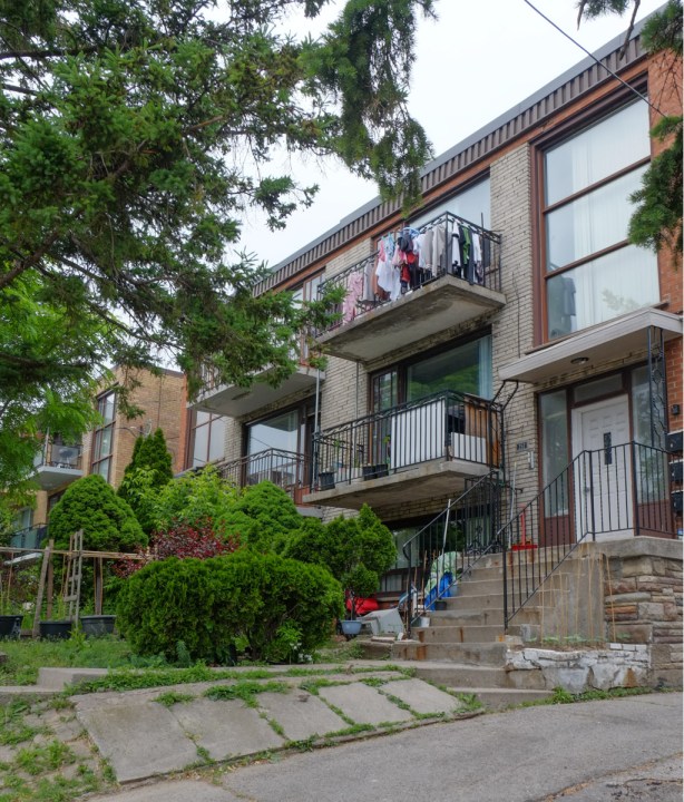 laundry on the balcony of a small apartment building