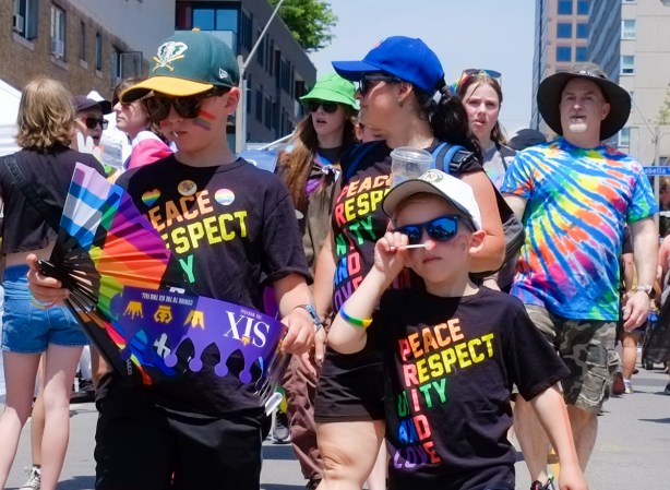 two boys and their mother wearing t shirts that say peace respect unity