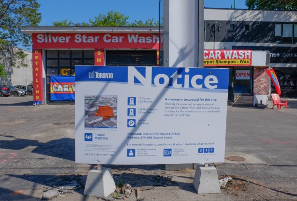 silver Star car wash on dupont street with a blue and white development notice in front