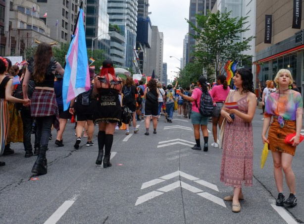 dyke march, pride toronto, people watching parade pass by on Bloor street