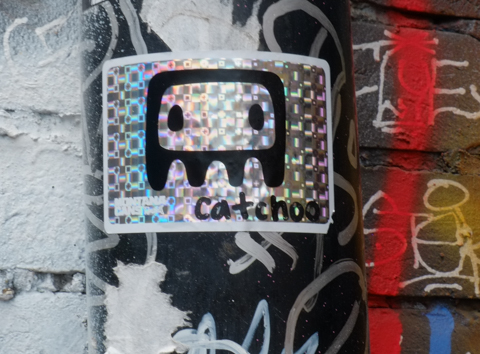a sticker by cathcoo of a face on shiny silver background