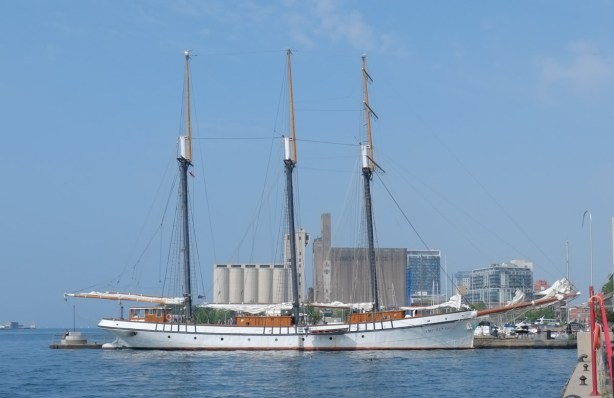 Empire Sandy tall ship with three masts is moored or docked in Toronto harbour