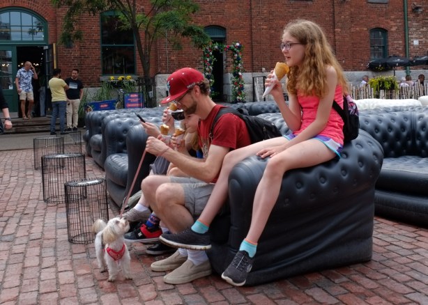 a family eating ice cream while seated in the distillery district