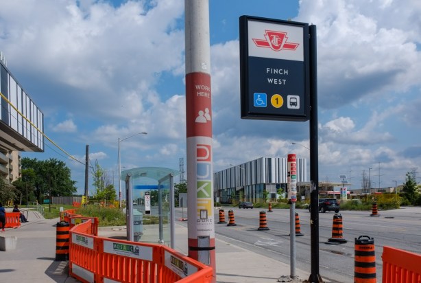 Keele street, looking north from Finch, Finch West subway station sign and striped buildings