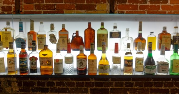 part of a display of liquor bottles, some of the gooderham and worts distillery products over the years, Ballentines, and Hiram Walker products, Government House rum, 
